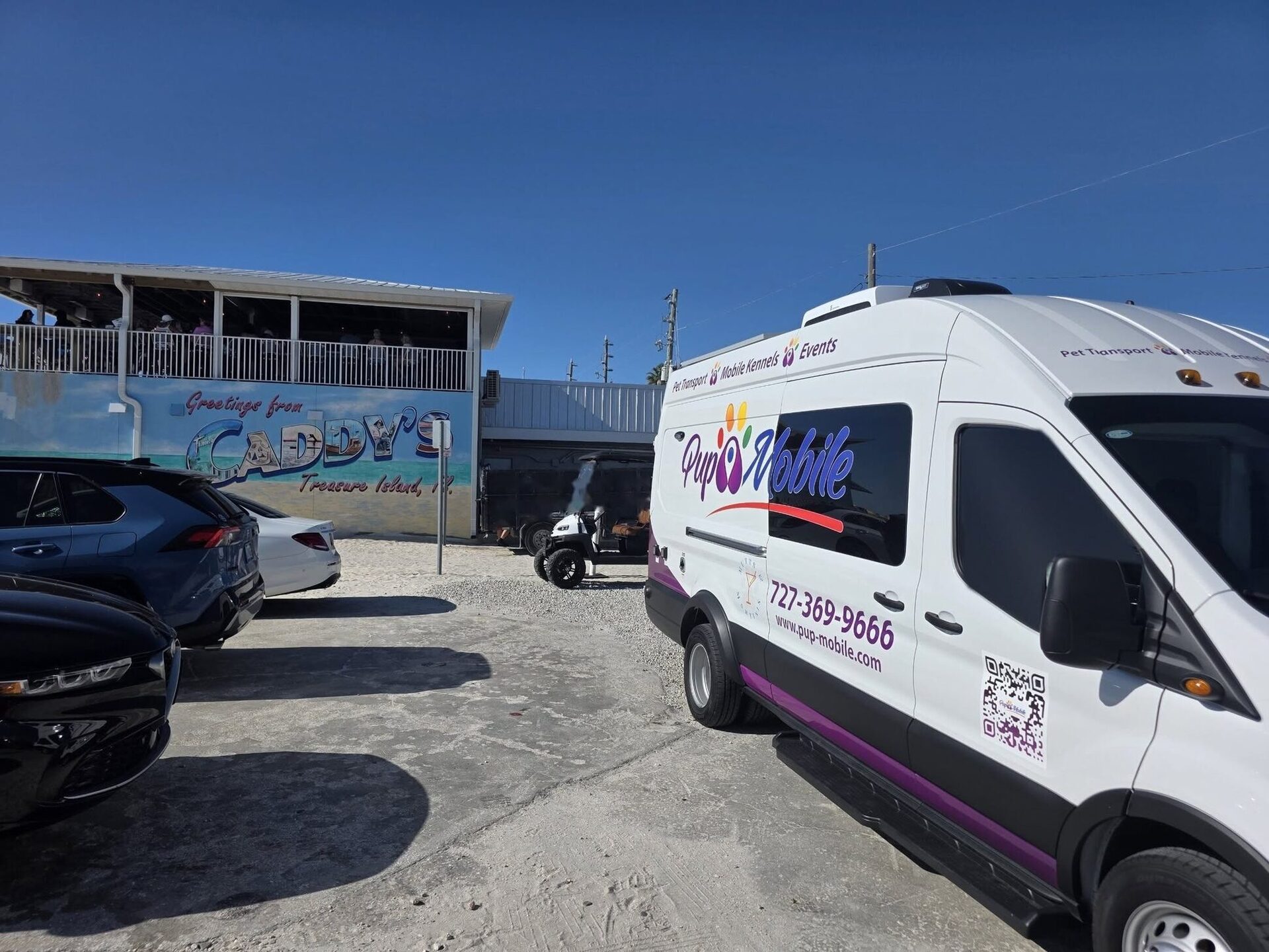 The Pup Mobile van parked at a curb
