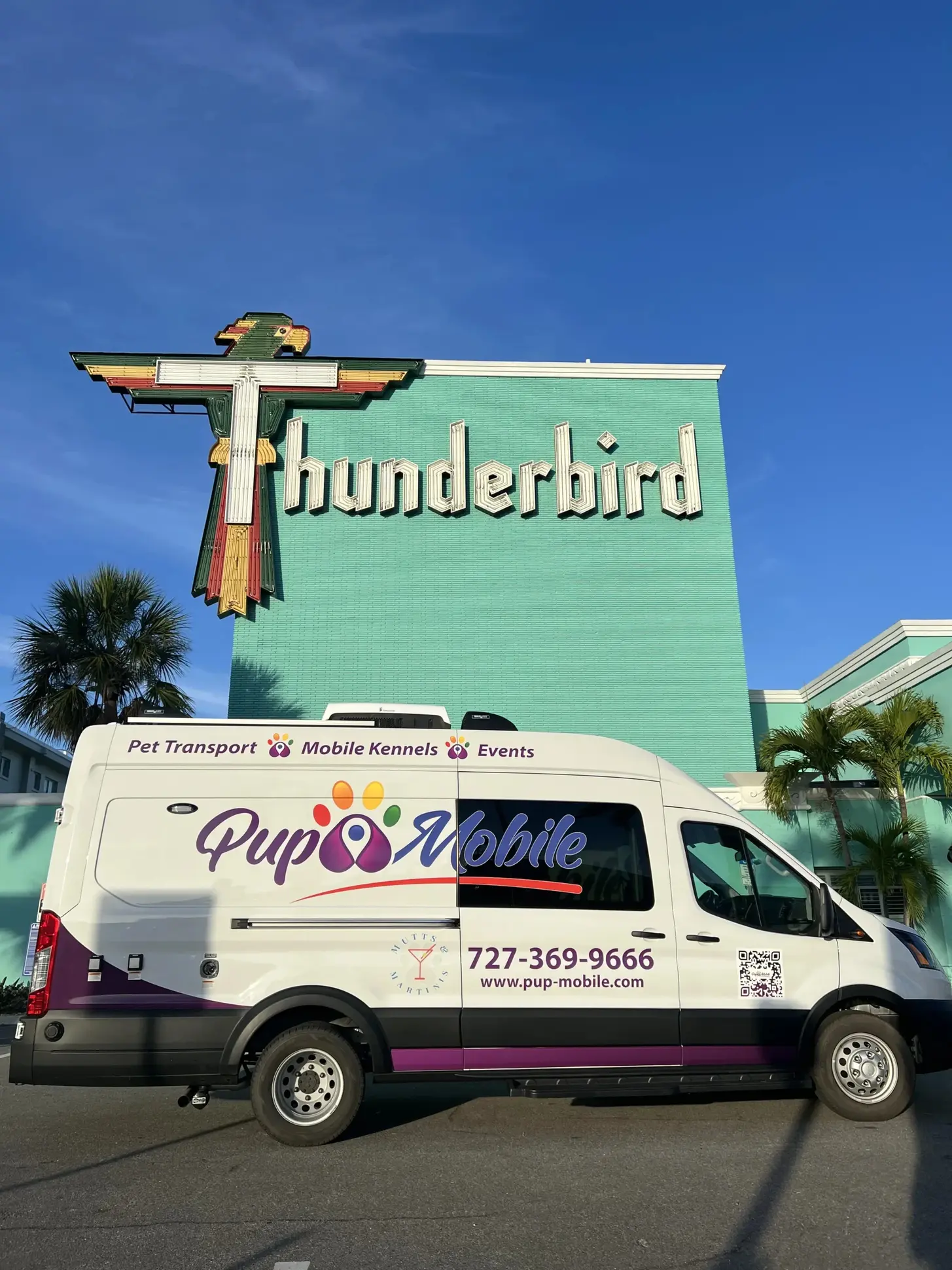 The Pup Mobile van under the Thunderbird Beach Resort sign